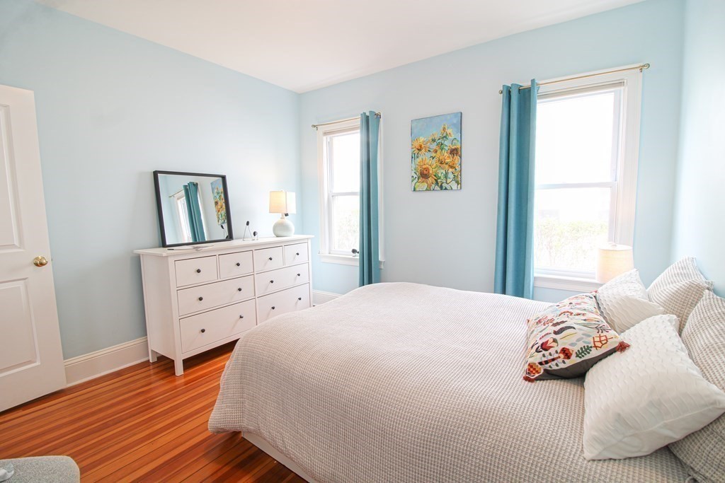 10 Marlboro Street, Unit 1 Belmont, MA 02478 - Photo 12 of 20 a bedroom with a bed and wooden floor