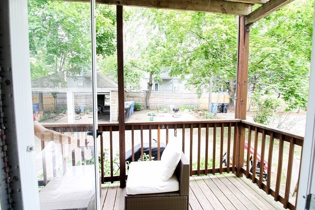 10 Marlboro Street, Unit 1 Belmont, MA 02478 - Photo 16 of 20 a view of a chair and table on the deck