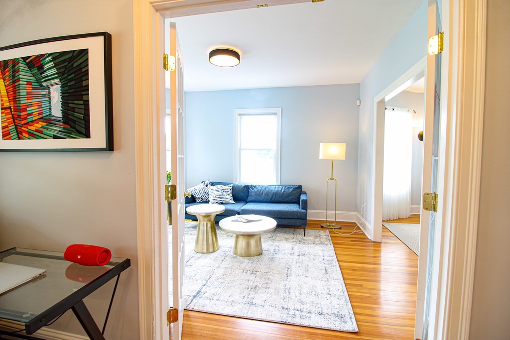 10 Marlboro Street, Unit 1 Belmont, MA 02478 - Photo 3 of 20 a living room with a couch and a table