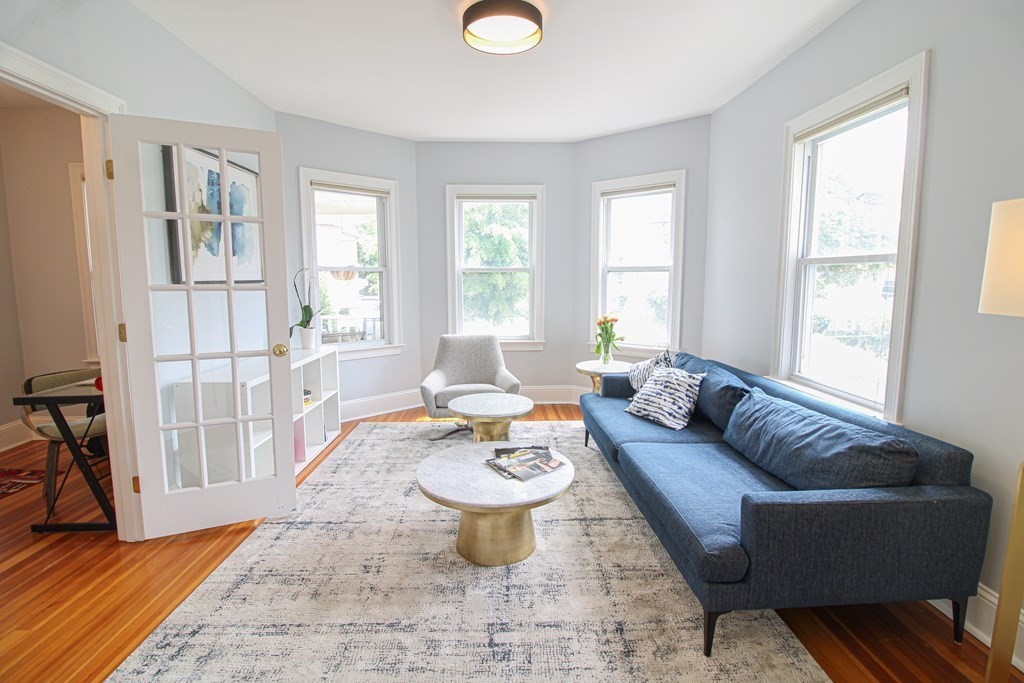 10 Marlboro Street, Unit 1 Belmont, MA 02478 - Photo 5 of 20 a living room with furniture and a table