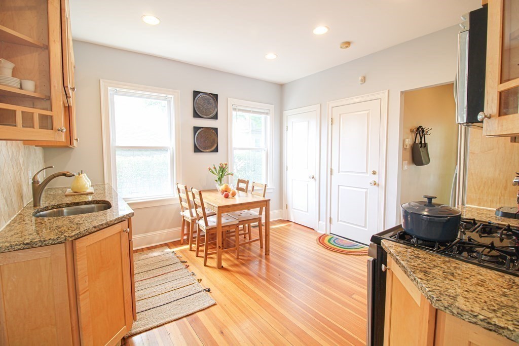 10 Marlboro Street, Unit 1 Belmont, MA 02478 - Photo 7 of 20 a living room with granite countertop furniture a sink a dining table and wooden floor