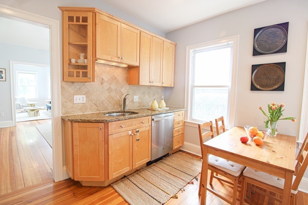 10 Marlboro Street, Unit 1 Belmont, MA 02478 - Photo 8 of 20 a kitchen with granite countertop cabinets a sink and a window