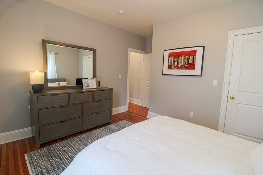 10 Marlboro Street, Unit 1 Belmont, MA 02478 - Photo 10 of 20 a bedroom with a bed and a mirror on dresser