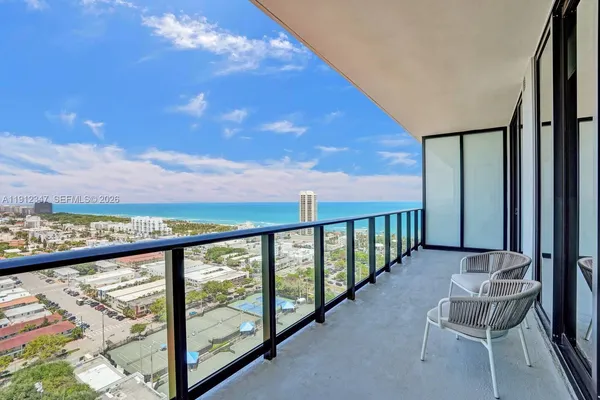 a view of a chairs and table in the balcony