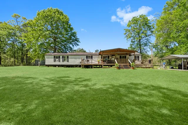 a view of a house with a yard porch and sitting area