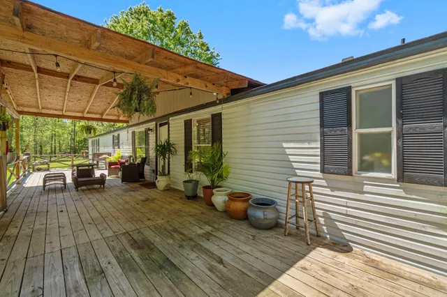 a view of a patio with table and chairs and wooden floor