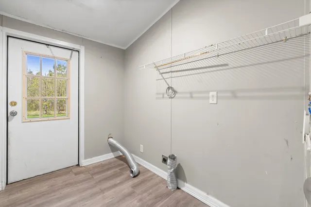 a view of a room with rack on the wall and a window