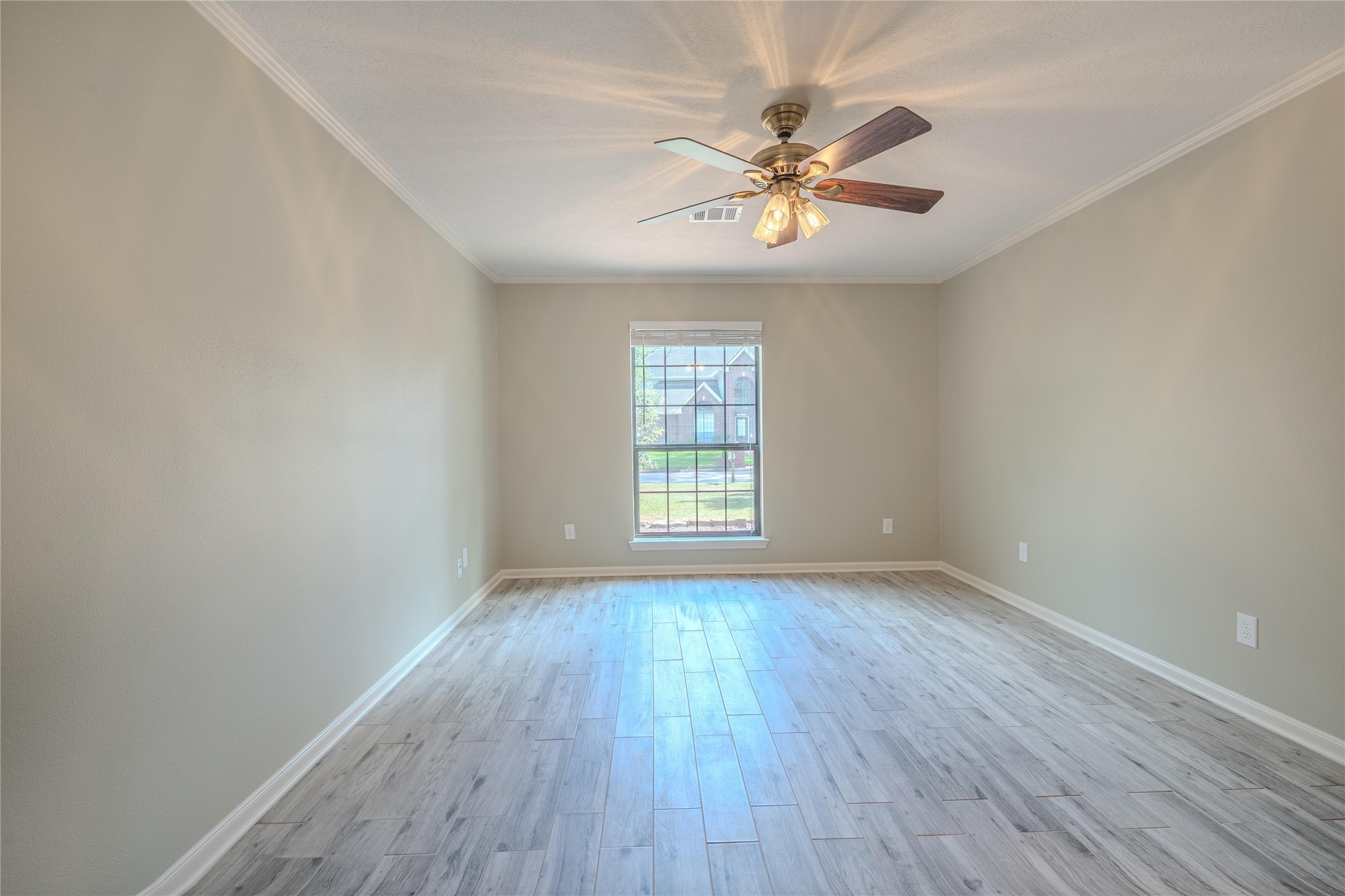 5938 Theall Road Houston, TX 77066 - Photo 17 of 35 a view of an empty room with wooden floor and a window
