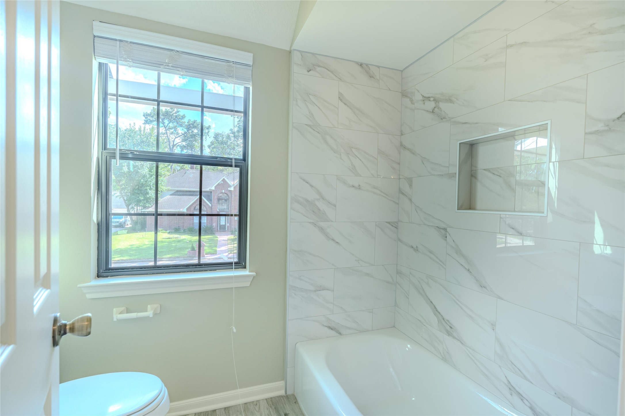 5938 Theall Road Houston, TX 77066 - Photo 24 of 35 a bath room with a toilet a bath tub and a shower