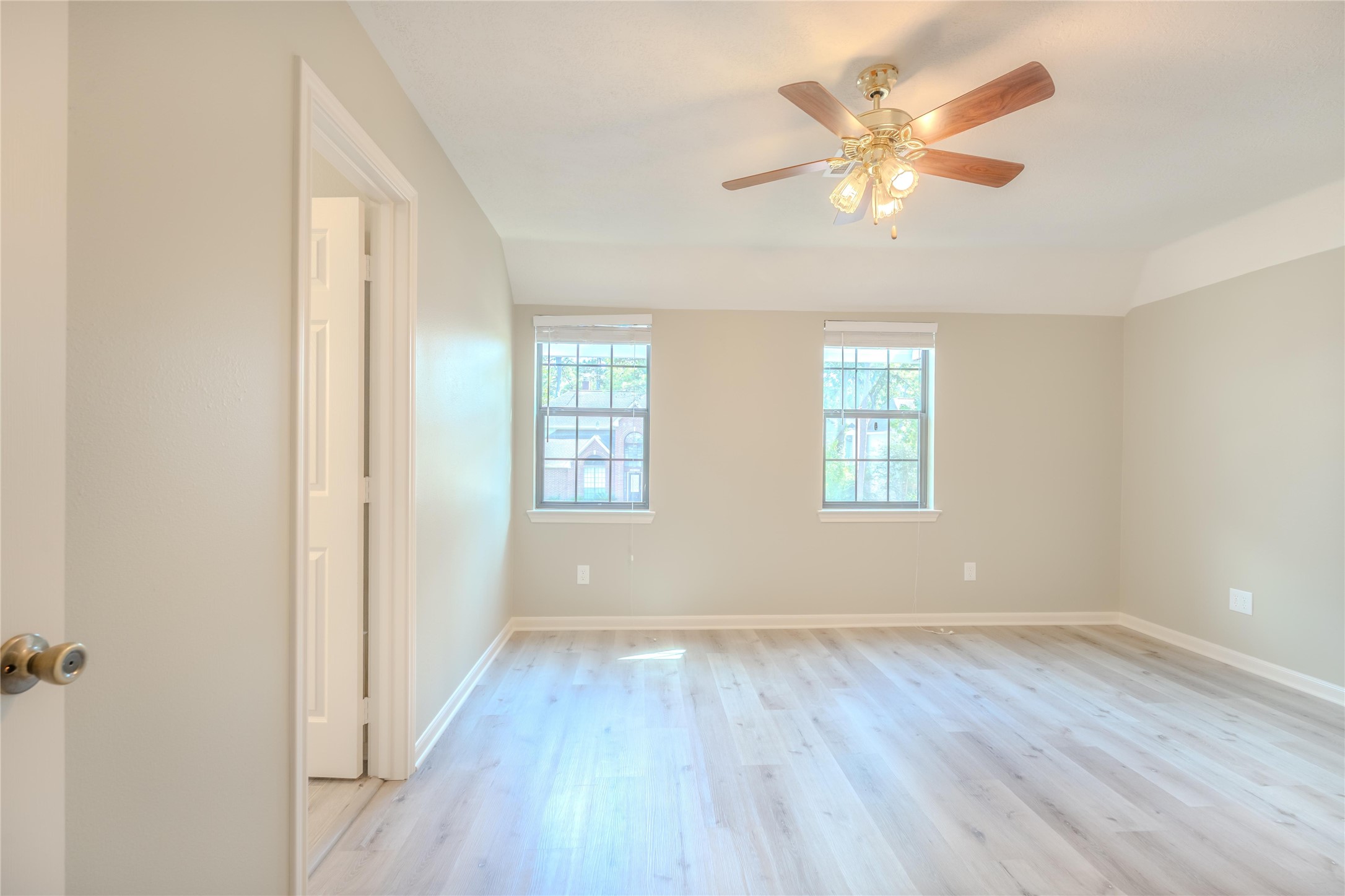 5938 Theall Road Houston, TX 77066 - Photo 26 of 35 an empty room with wooden floor and windows