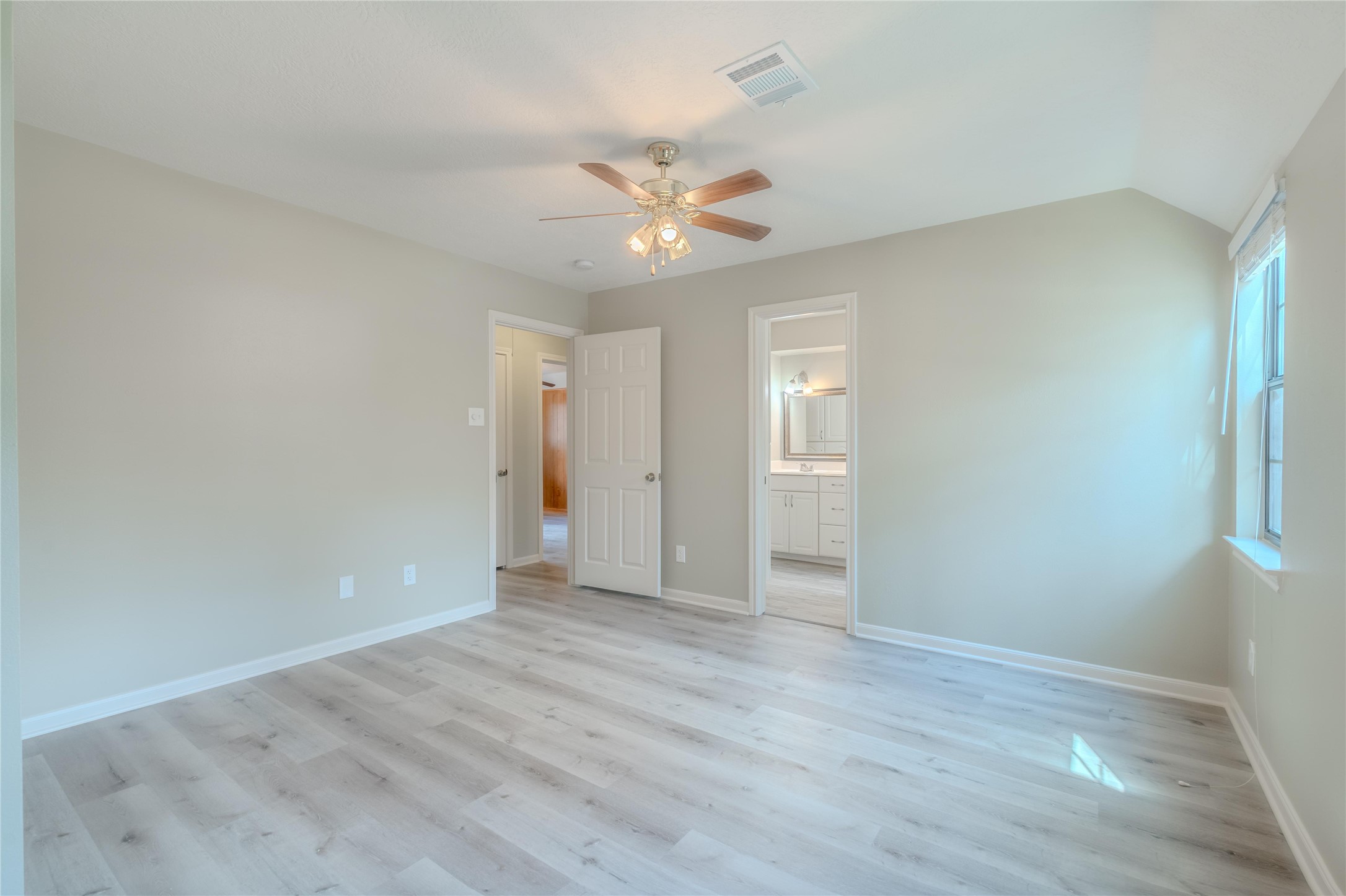 5938 Theall Road Houston, TX 77066 - Photo 27 of 35 a view of an empty room with chandelier fan and wooden floor