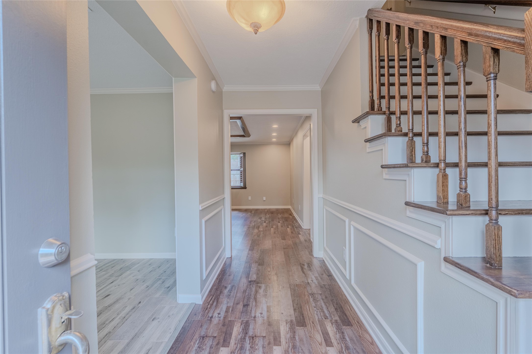 5938 Theall Road Houston, TX 77066 - Photo 5 of 35 a view of a hallway with wooden floor and staircase