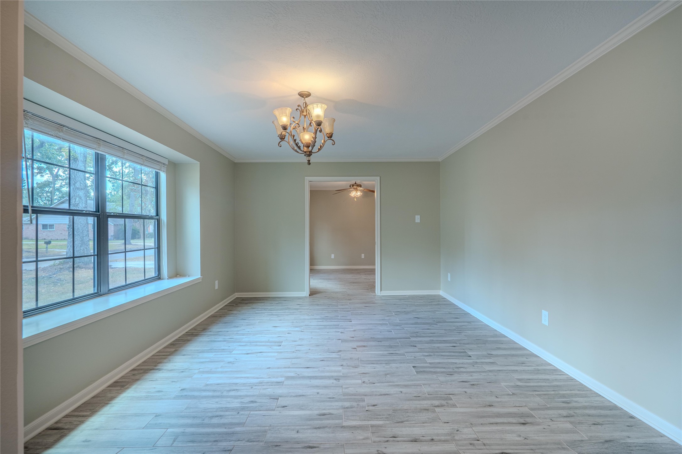 5938 Theall Road Houston, TX 77066 - Photo 6 of 35 wooden floor in an empty room with a window