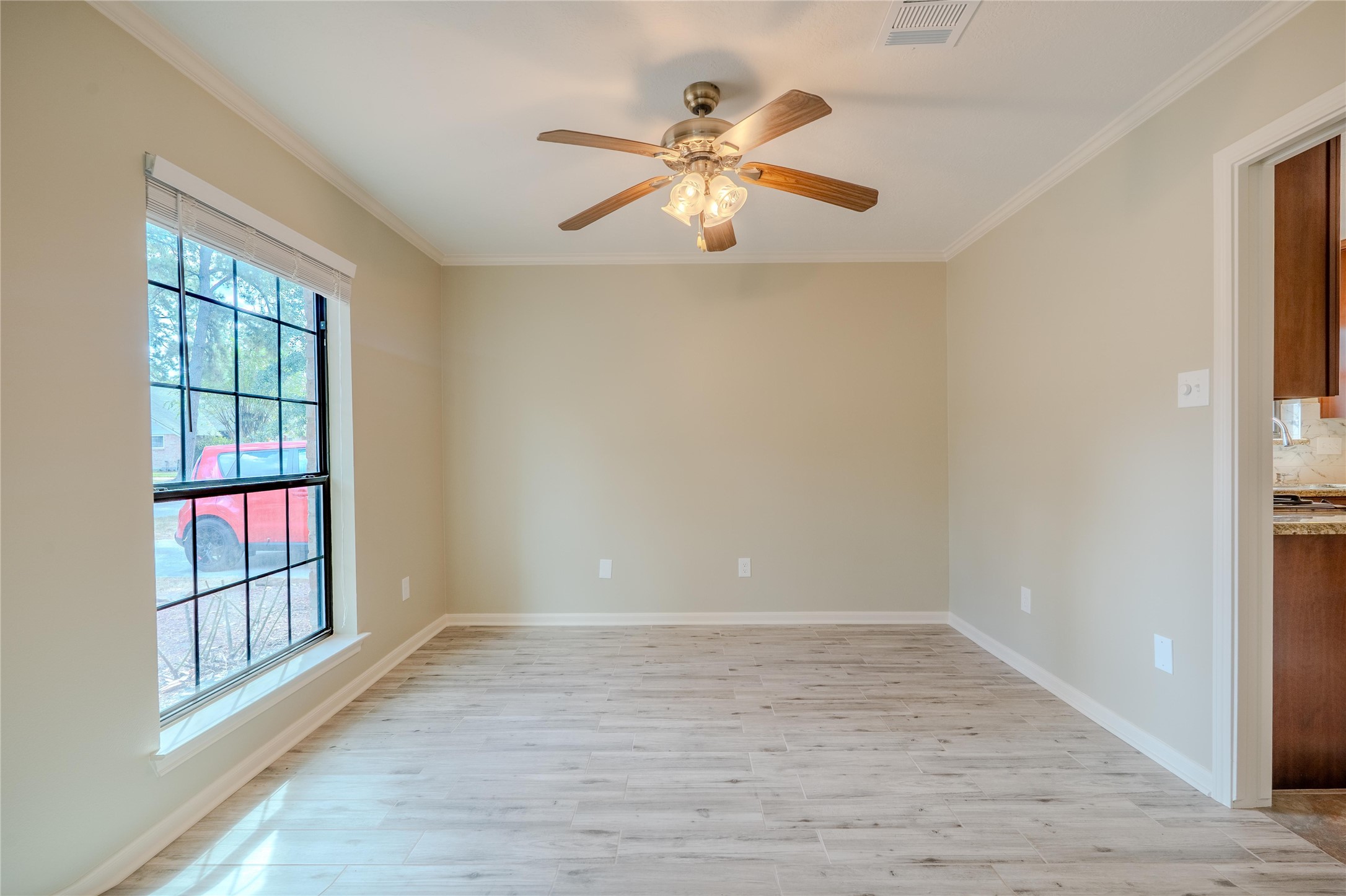 5938 Theall Road Houston, TX 77066 - Photo 7 of 35 wooden floor in an empty room with a window