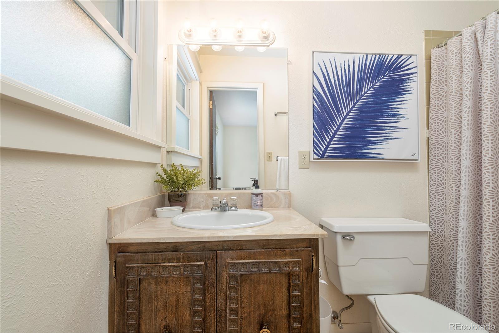643 Furman Way Boulder, CO 80305 - Photo 11 of 25 a bathroom with a sink a toilet and mirror