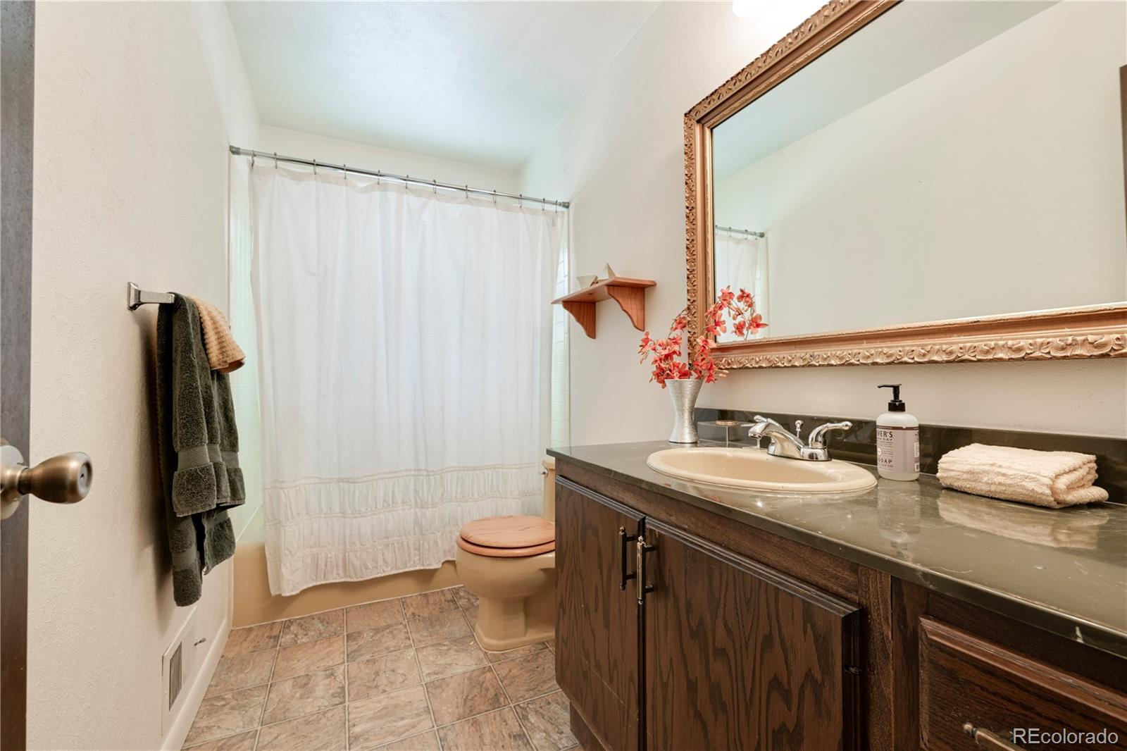 643 Furman Way Boulder, CO 80305 - Photo 14 of 25 a bathroom with a sink toilet and shower