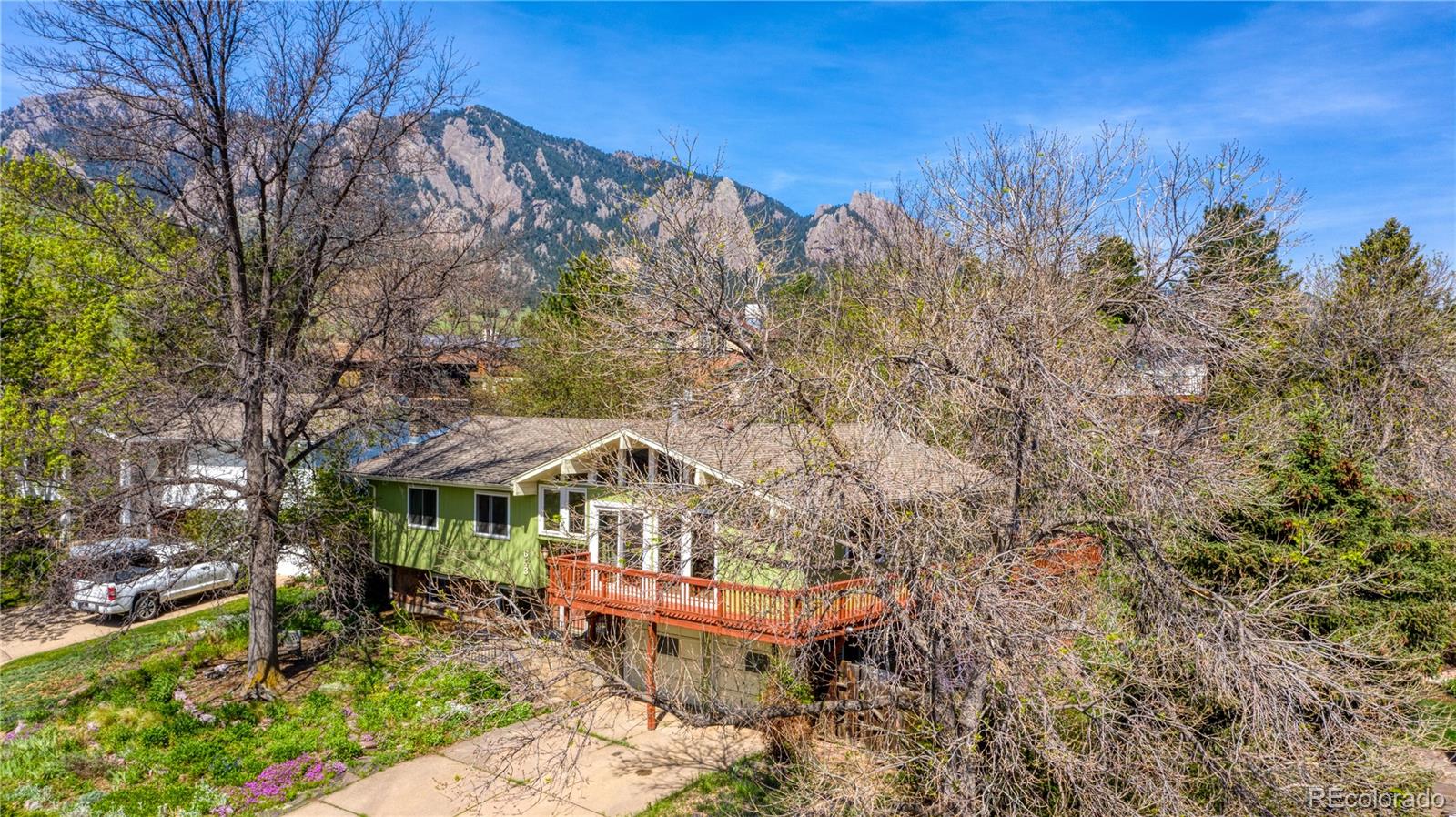643 Furman Way Boulder, CO 80305 - Photo 21 of 25 a backyard of a house with table and chairs under an umbrella