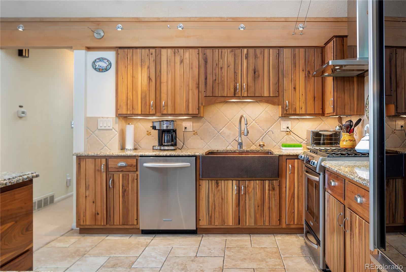 643 Furman Way Boulder, CO 80305 - Photo 5 of 25 a kitchen with a refrigerator and a sink