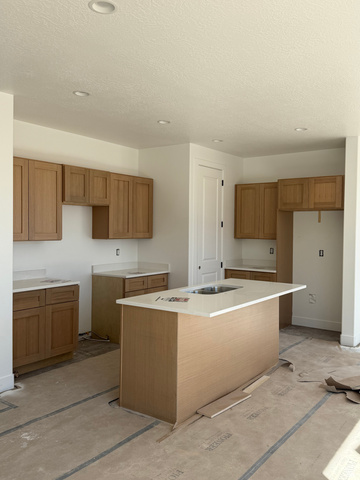 4956 North 925 East, Unit 87 Enoch, UT 84721 - Photo 2 of 12 Kitchen with an island with sink, wood finish cabinetry, a textured ceiling, and recessed lighting