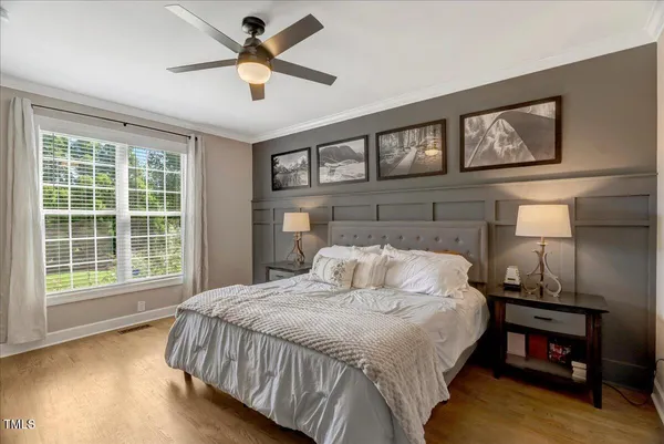 a bedroom with a large bed and a window
