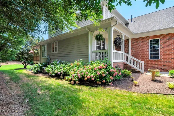 a view of a house with a backyard and garden