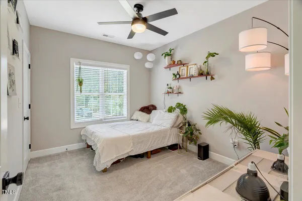 a bedroom with a bed and ceiling fan