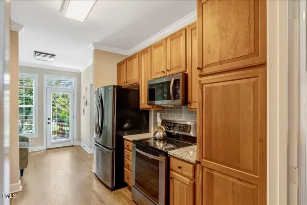 a kitchen with stainless steel appliances granite countertop a refrigerator stove and microwave