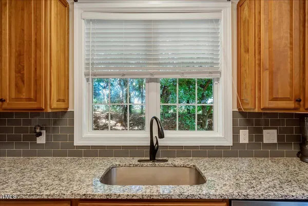 a view of a kitchen with a sink and a window
