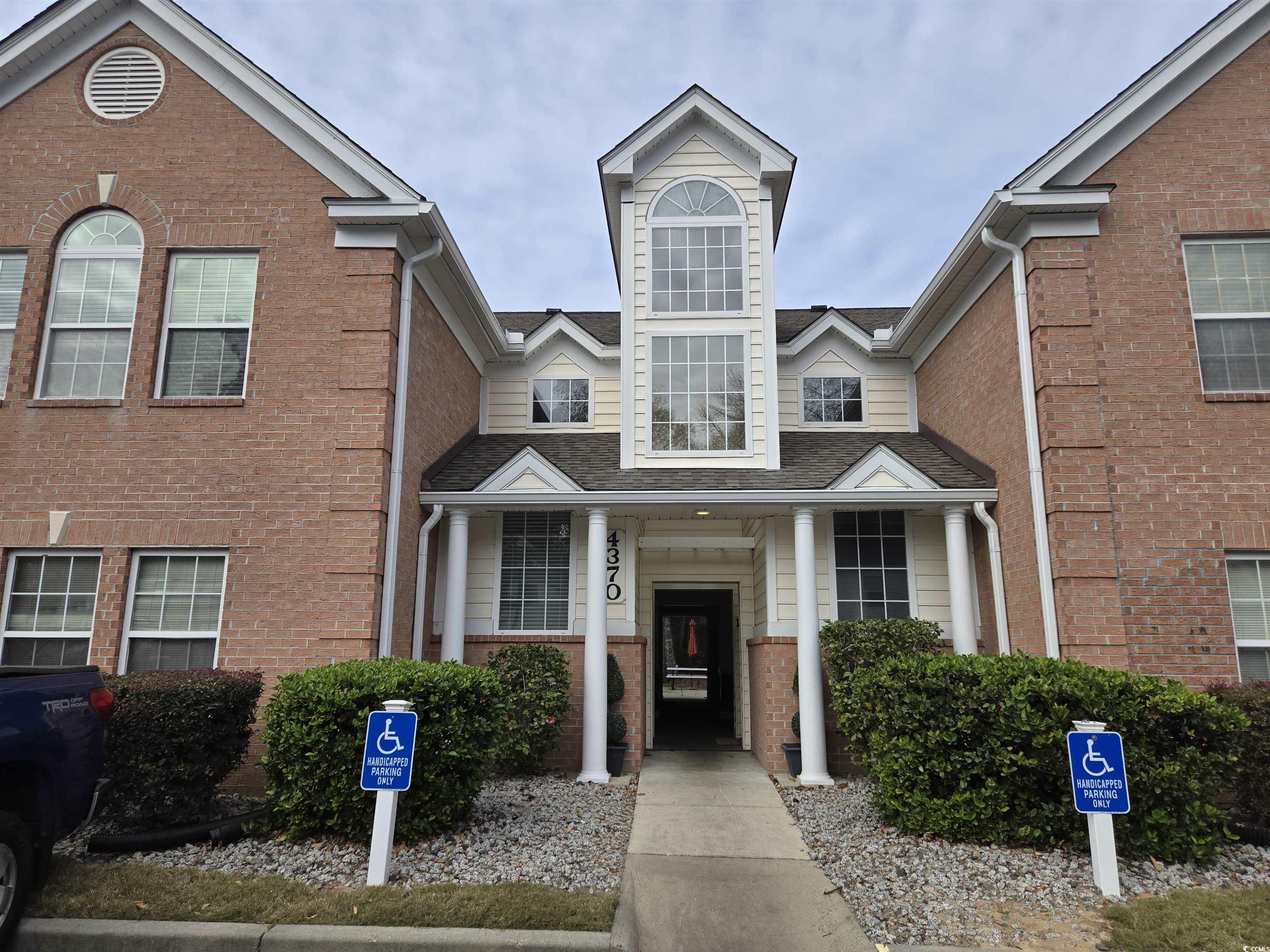 View of front of house featuring brick siding