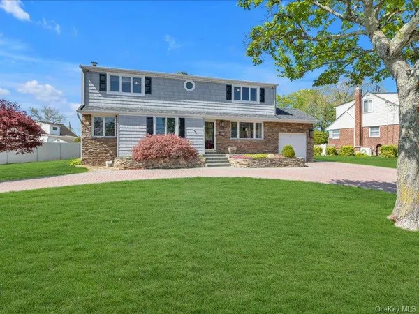 a front view of house with yard and green space