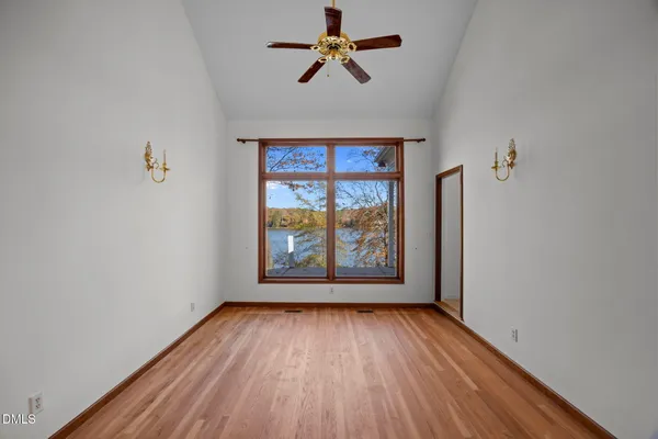 wooden floor in an empty room with a window