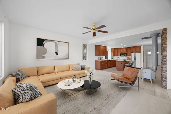 a living room with furniture and view of kitchen