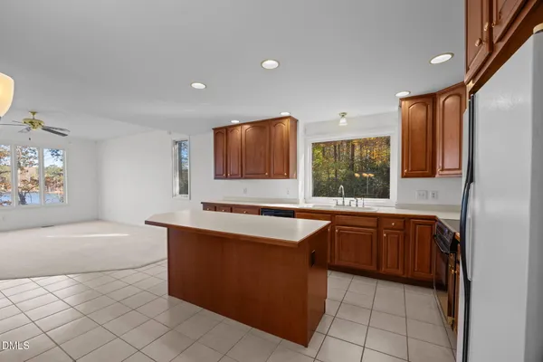 a large kitchen with stainless steel appliances granite countertop a sink and a granite counter tops