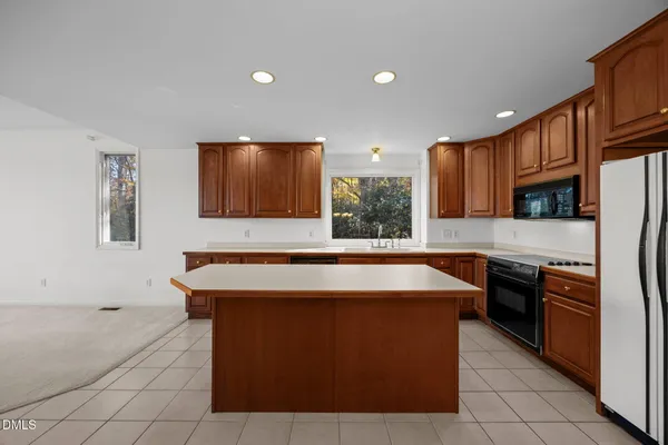 a kitchen with stainless steel appliances granite countertop a stove a sink dishwasher and a refrigerator