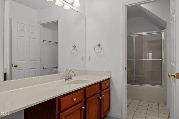 a bathroom with a sink a mirror and a shower
