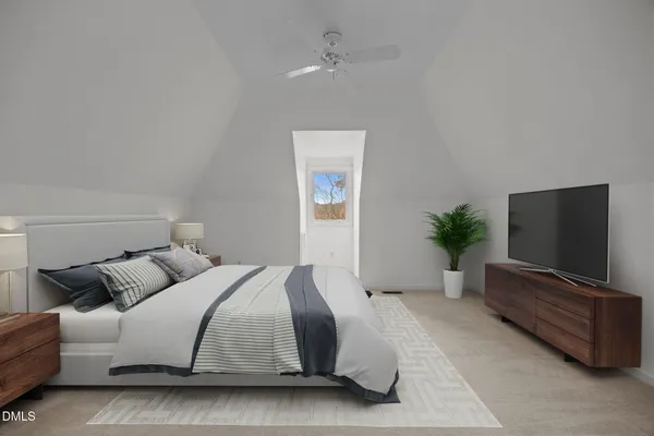 a spacious bedroom with a bed and a flat screen tv