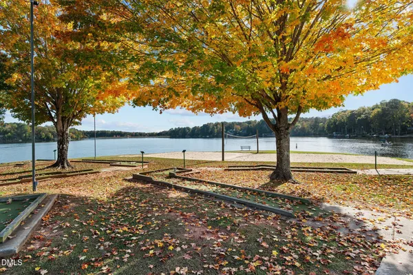 a view of a house with pool and lake view