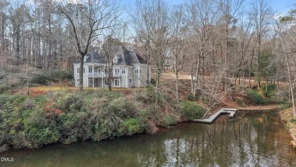 a view of a lake with a house in the background