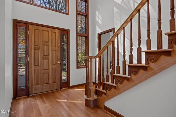 a view of an entryway with wooden floor and door