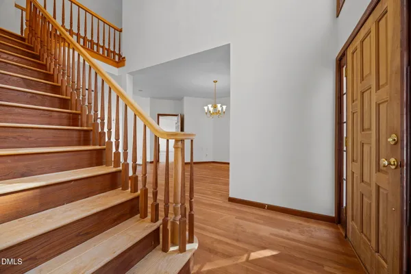 a view of entryway with wooden floor and stairs