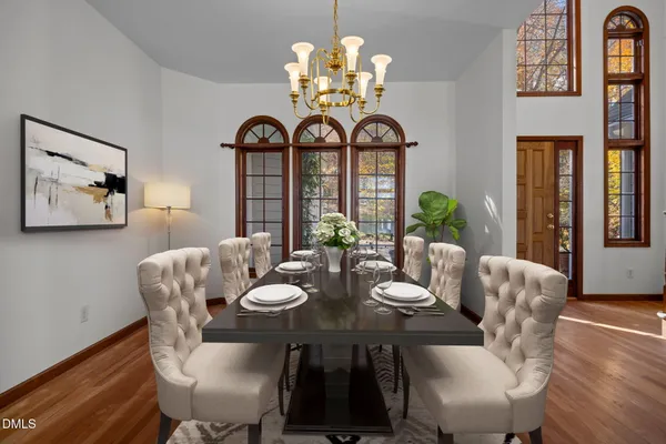 a view of a dining room with furniture wooden floor and chandelier