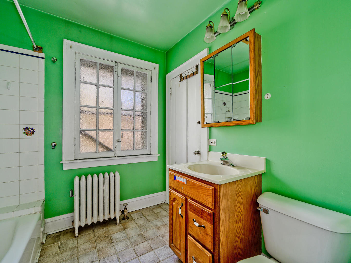 6457 North Bell Avenue, Unit 2 Chicago, IL 60645 - Photo 12 of 14 a bathroom with a sink a toilet and mirror