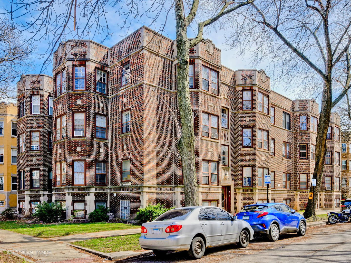 6457 North Bell Avenue, Unit 2 Chicago, IL 60645 - Photo 2 of 14 a front view of a building with lot of cars and trees