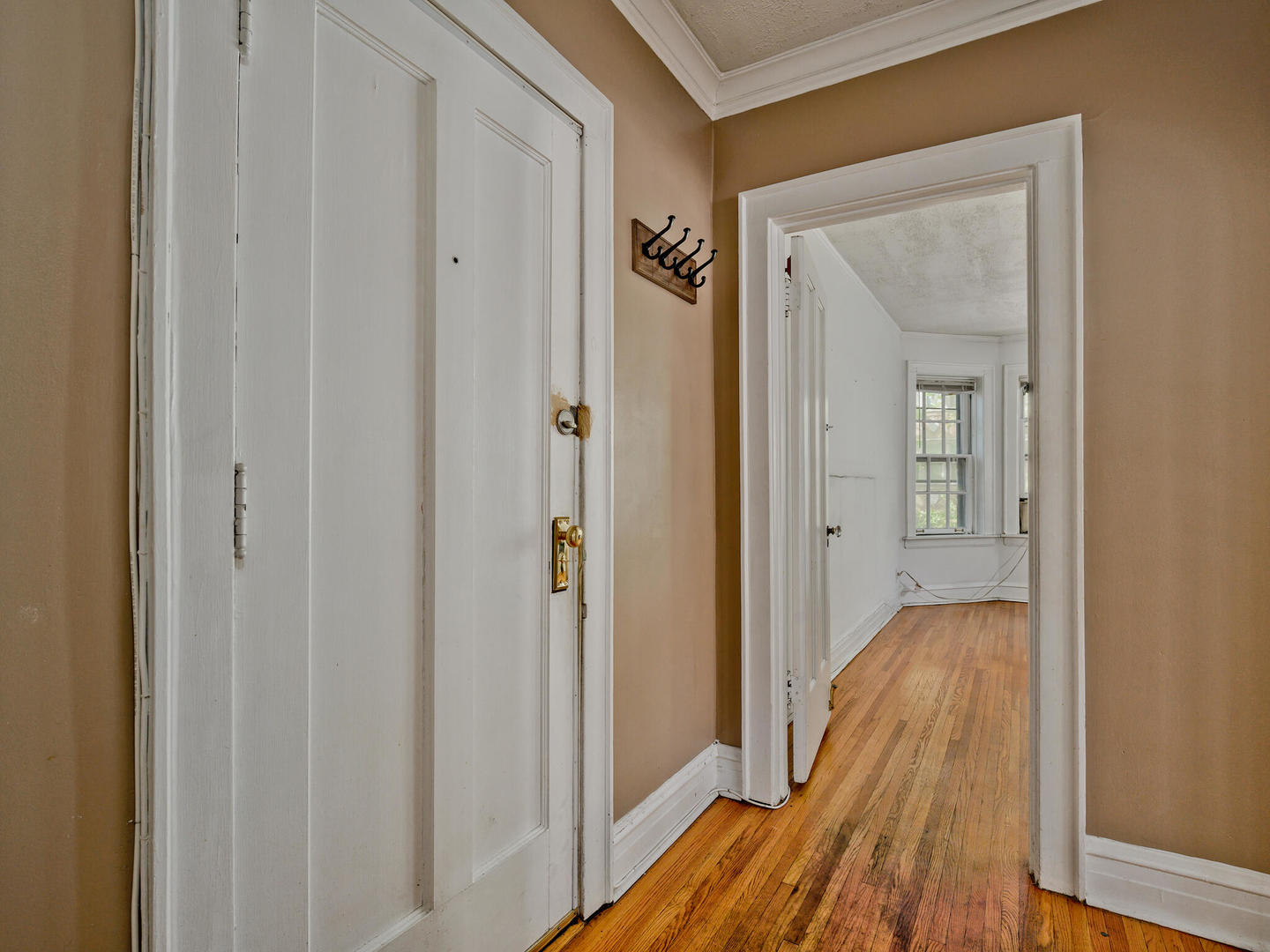 6457 North Bell Avenue, Unit 2 Chicago, IL 60645 - Photo 3 of 14 a view of a hallway with wooden floor and closet