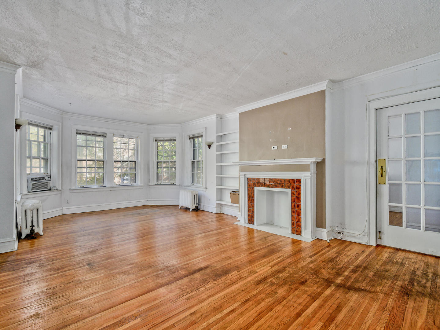 6457 North Bell Avenue, Unit 2 Chicago, IL 60645 - Photo 4 of 14 a view of an empty room with window and wooden floor