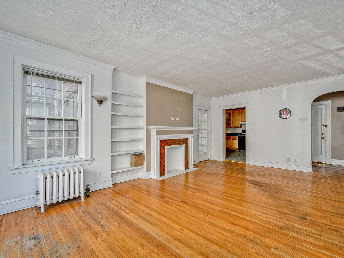 6457 North Bell Avenue, Unit 2 Chicago, IL 60645 - Photo 6 of 14 a view of an empty room with a fireplace and a window