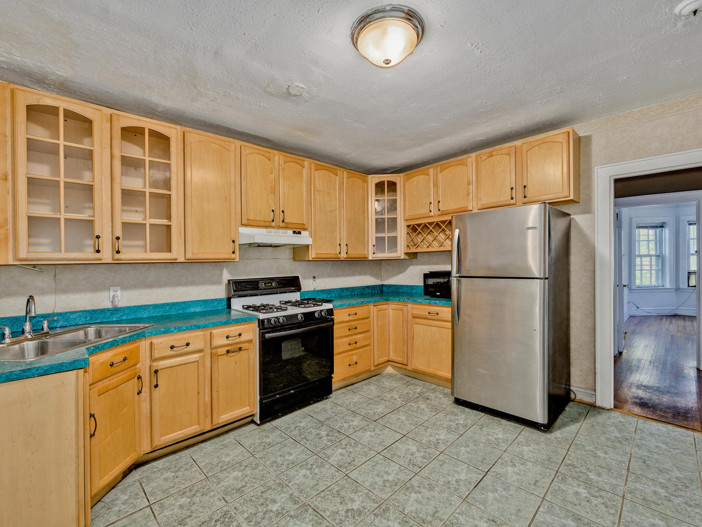 6457 North Bell Avenue, Unit 2 Chicago, IL 60645 - Photo 7 of 14 a kitchen with stainless steel appliances granite countertop a refrigerator sink and stove