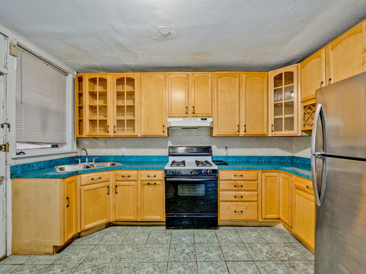 6457 North Bell Avenue, Unit 2 Chicago, IL 60645 - Photo 8 of 14 a kitchen with stainless steel appliances granite countertop a stove and a refrigerator