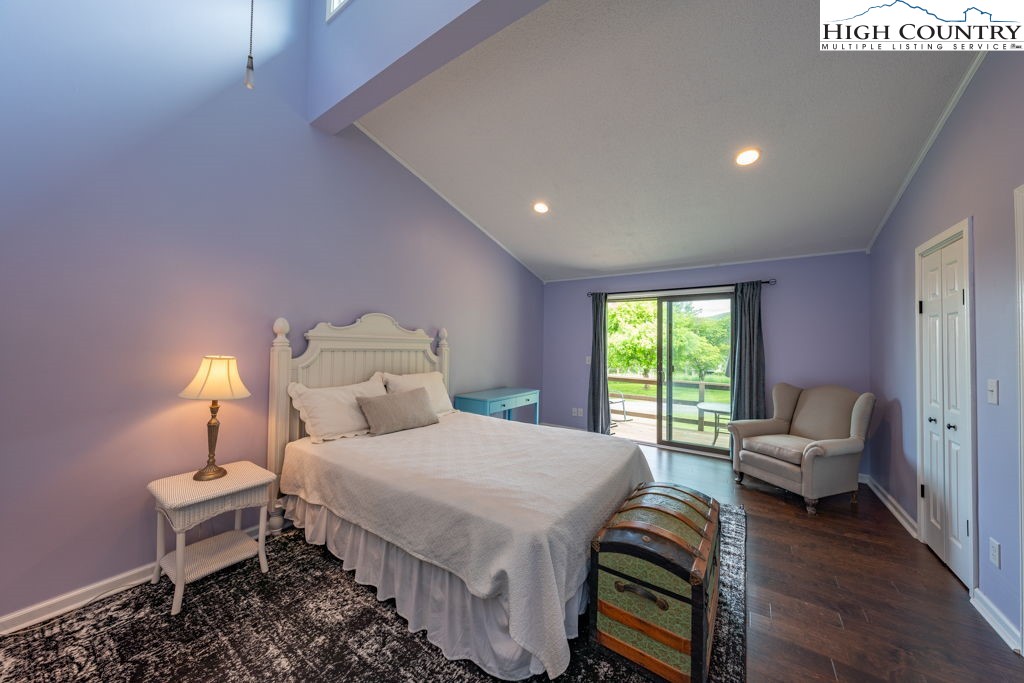 132 Juniper Drive, Unit 132 Boone, NC 28607 - Photo 12 of 36 a bedroom with a bed and wooden floor