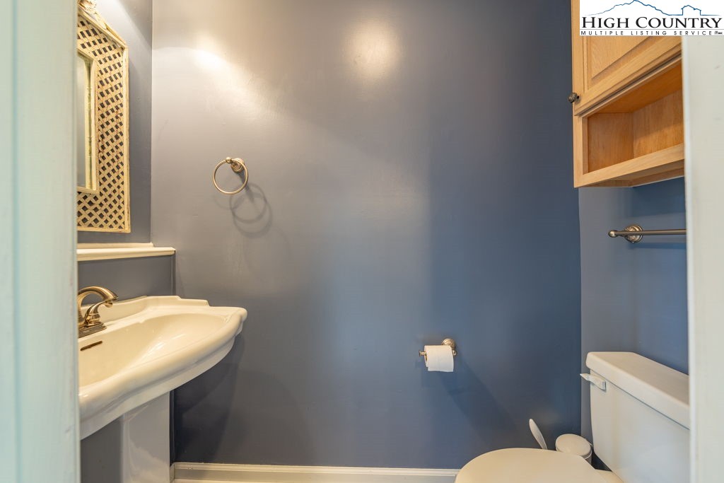 132 Juniper Drive, Unit 132 Boone, NC 28607 - Photo 8 of 36 a bathroom with a sink a toilet and mirror